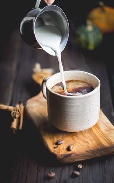 someone is pouring coffee into a cup