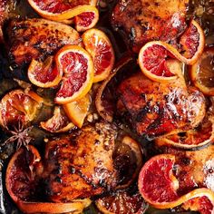 a close up of some meat with blood oranges on it