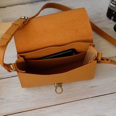 "Every handbag is made with 100% genuine leather. This bag is the perfect helper, you can put a lot of objects in it and your hands and pockets will be free. Size bag: - Length -- 8.6\" (22 cm) - Height -- 6.3\" (16 cm) - Deepth -- 2.7\" (7 cm) ----------------------------------------------------- Each accessory can differ in color from the photo, which makes them unique. Since this is a natural leather, small natural irregularities, like scars, stitches, bumps etc. are not reworked. They emphas Leather Envelope Bag With Detachable Strap, Daily Use Soft Leather Rectangular Camera Bag, Daily Use Rectangular Soft Leather Camera Bag, Daily Use Soft Leather Camera Bag, Leather Phone Pouch Bag For Office, Leather Flap Box Bag For Everyday, Leather Clutch Phone Bag With Adjustable Strap, Rectangular Soft Leather Belt Bag For Daily Use, Leather Pouch Camera Bag For Daily Use