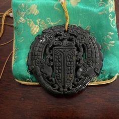 This Is An Absolutely Gorgeous Chinese Carved Black Jade Two Dragon & Cicada Pendant Necklace. In Chinese Mythology, Dragon Is The Symbol Of Strength And The Cicada The Symbol Of Resurrection. It Is Quite Large Measuring 2.75 X 2.75 Inches. Can Be Worn With Any Color Silk Or Suede Cord. Comes In A Satin Pouch. In Unused Vintage Condition. Traditional Black Medallion Necklace, Antique Black Necklace With Large Pendant, Engraved Jade Amulet Jewelry, Green Carved Amulet Necklace, Vintage Carved Jade Jewelry, Chinese Jade Pendant, Jade Dragon Pendant, Chinese Mythology, Symbols Of Strength