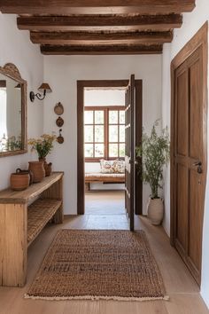 an entry way with wooden doors and bench in the center, along with potted plants on either side