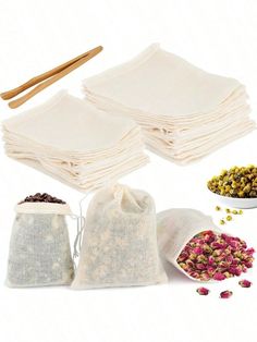 the contents of a tea bag are shown with two bags filled with loose flowers and three wooden spoons