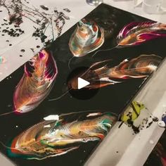 an artistic painting is being worked on by someone in the process of creating something that looks like feathers