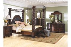 a bedroom scene with focus on the four poster bed