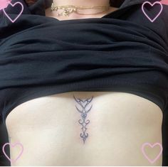 a woman's lower back tattoo with pink hearts around her neck and an arrow on the side