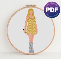 a cross stitch pattern of a woman in a yellow dress