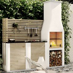 an outdoor fireplace with wood and pots on it