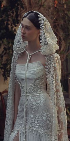 a woman in a white wedding dress and veil