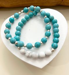 A combination of turquoise and white Howlite bracelets create a fresh summery look. Can be worn casually or dressy. Adds a touch of boho chic to any emsemble. Gives off a calming, compassionate patient vibe. Check out my other items on Etsy at        etsy.me/4aWMaHB On Instagram at          https://www.instagram.com/beaditdesignsbyjc/ CARE:  Do not submerge in water,  roll bracelets on wrist remove at night Turquoise Howlite Beaded Bracelets, Everyday Hypoallergenic Turquoise Beaded Bracelets, Hypoallergenic Turquoise Beaded Bracelets For Healing, Everyday Turquoise Hand-strung Stretch Bracelet, Everyday Hand-strung Turquoise Stretch Bracelet, Bracelets On Wrist, Stretch Beaded Bracelets Diy, Howlite Bracelet, Vibe Check