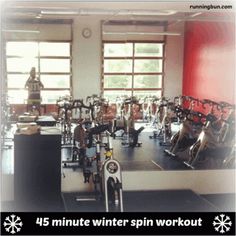 a room filled with lots of different types of exercise equipment in front of large windows