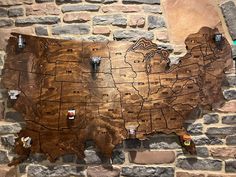 a wooden united states map on a brick wall