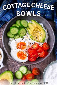 a bowl filled with eggs, tomatoes and cucumber next to other foods on a table