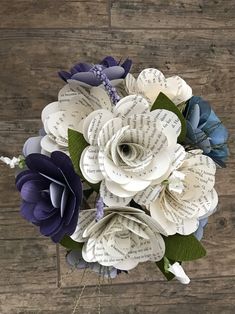 a bouquet of paper flowers on top of a wooden table