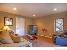 a living room filled with furniture and a flat screen tv