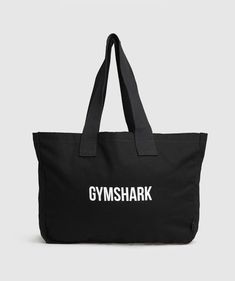 TOTE BAGS >>> 
Work? Tote. Gym? Tote. Shopping? Tote. • Classic lightweight canvas tote bag
• Gymshark wordmark 
SIZE & FIT
• 70cm x 34cm 
MATERIALS & CARE
• 100% Cotton 
SKU: I3A6Q-BB2J Black Cotton Shoulder Bag With Logo, Everyday Cotton Bags With Logo, Black Canvas Bag With Logo For Everyday, Sporty Rectangular Cotton Bag, Black Canvas Bag With Logo, Black Canvas Bag For Weekend, Black Canvas Weekend Bag, Black Logo Canvas Tote Bag, Black Canvas Bag For The Weekend