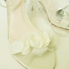 These are Absolutely Gorgeous Ivory Open Toe Heels by Melissa Sweet. Beautiful light ivory fabric with a very slight sheen, gorgeous romantic rosettes and leaves adorn the toe in whisps of sheer and organza fabrics. The inside of the sandal is a light blush color with a scalloped edge and blush labeling and stitching also, making them pretty for photographs! The sole is pretty as well, in a blush leather. They have a classic single strap over the toe, and adjustable buckles at the ankles. US Siz Cream Open Heel Wedding Sandals, Feminine Cream Open Toe Wedding Shoes, Cream Open Toe Sandals For Bridal Shower, Cream Ankle Strap Wedding Shoes, Cream Block Heel Wedding Sandals, Cream Open Toe Shoes For Wedding Guest, White Block Heel Wedding Shoes For Event, Beige Open Heel Wedding Heels, White Open Toe Wedding Shoes