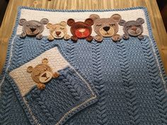 a crocheted blanket with teddy bears on it