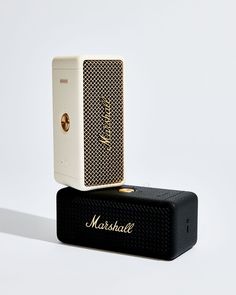 two speakers sitting on top of each other in front of a white background with the word marshall written on it