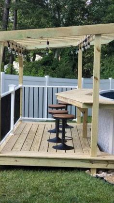 an outdoor hot tub and table in the backyard