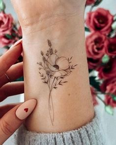 a woman's foot with a flower tattoo on the side of her left ankle