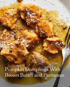 pumpkin dumplings with brown butter and parmesan on a white plate next to a fork