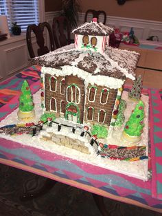 a large gingerbread house on top of a table