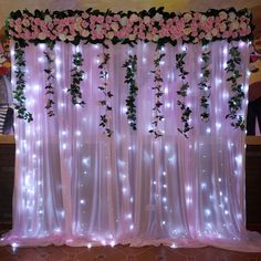 the curtain is decorated with flowers and lights