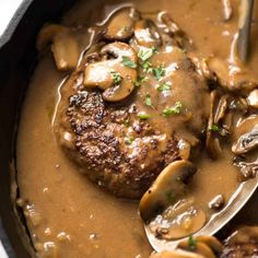 the meat is covered in mushrooms and gravy