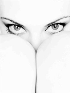 a woman's eyes with her hands over her face