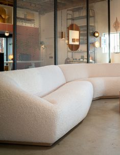 a large white couch sitting inside of a living room