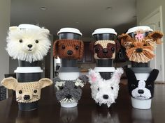 there are many coffee cups that have animals on the top and bottom one is made out of crochet