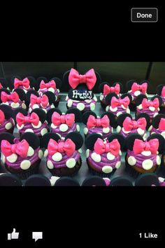 cupcakes with minnie mouse ears and pink bows are on display for the camera