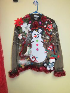 a snowman sweater hanging on the wall