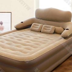 an inflatable bed sitting on top of a wooden floor