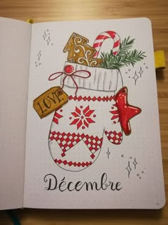 an open notebook with christmas decorations on it