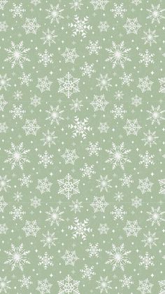 a green and white wallpaper with snowflakes on the bottom right hand corner