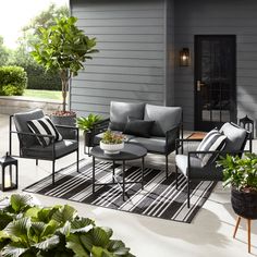 an outdoor patio with furniture and potted plants