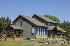 a large house sitting on top of a lush green field