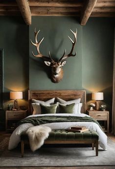 a bed room with a neatly made bed and a deer head mounted on the wall