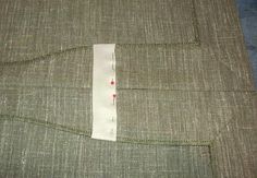 a piece of fabric that has been stitched together with white thread and red dots