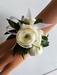 a bride's wrist with white flowers on it