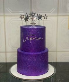 a purple cake with stars on top and the word virture written on it