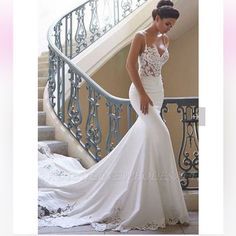 a woman in a wedding dress standing on stairs