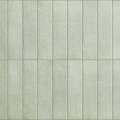 a white tile wall with vertical lines on it