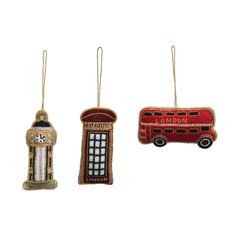 three ornaments in the shape of london and a red bus, one with a cat on it