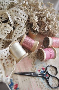 some spools of thread and scissors on a table