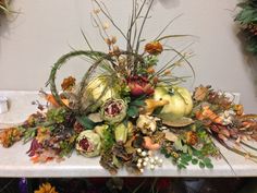 a table topped with lots of different types of flowers and plants on top of it