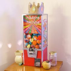 an old fashioned gummy machine sitting on top of a wooden table