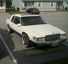 a white station wagon parked in a parking lot