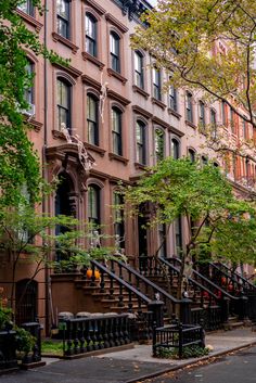 an apartment building with many windows and balconies on the side of the street